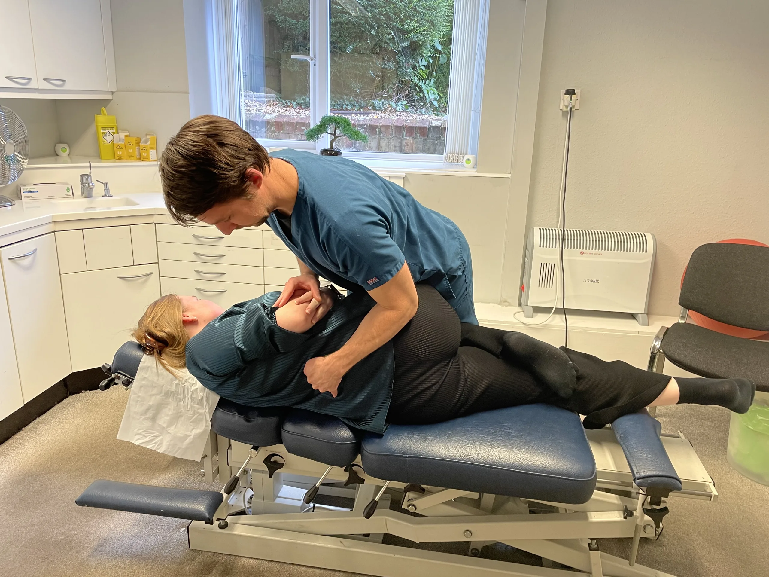 Alex adjusting lower back, Guildford Chiropractor